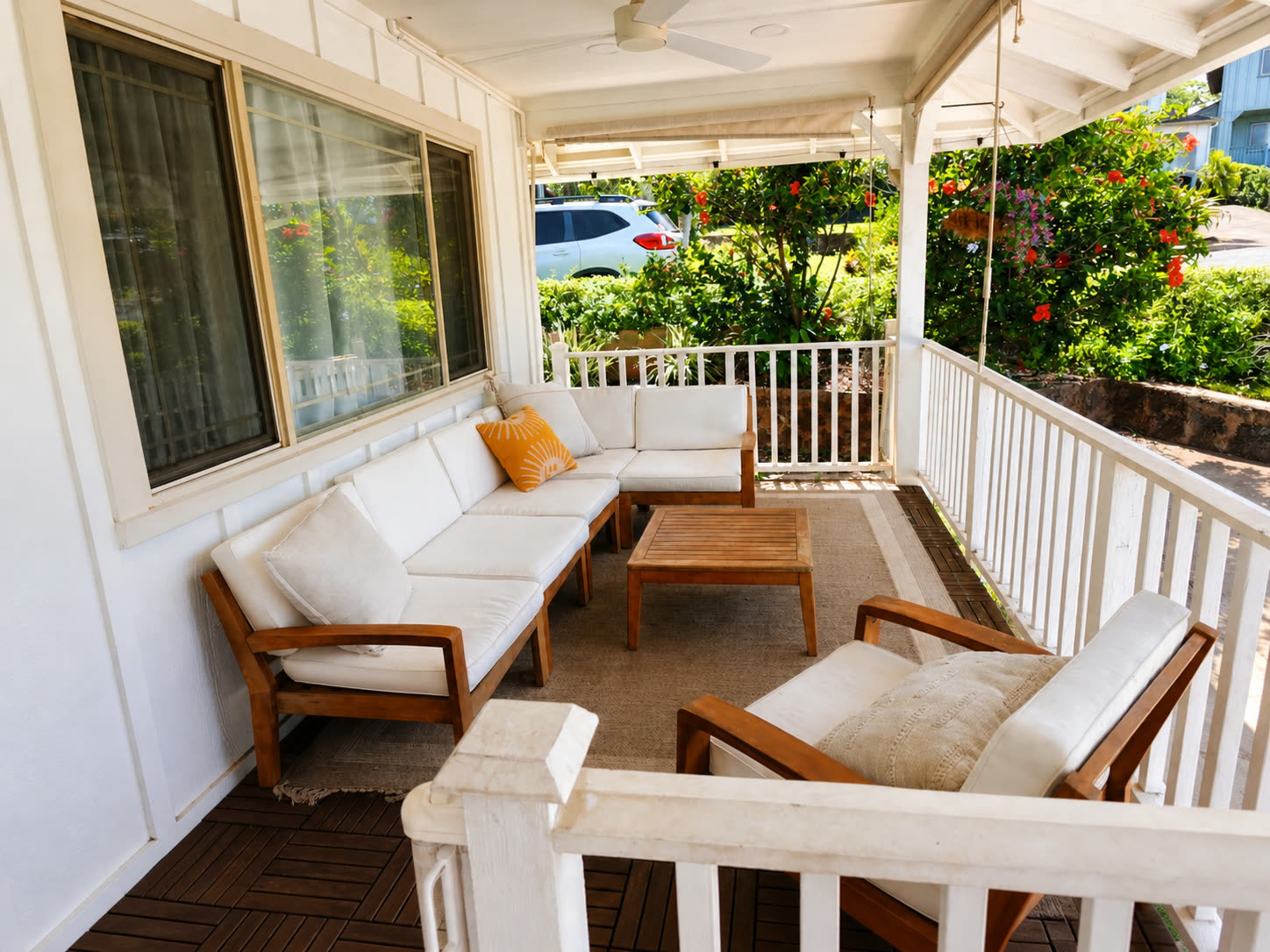 Front lanai with white outdoor sectional and hibiscus