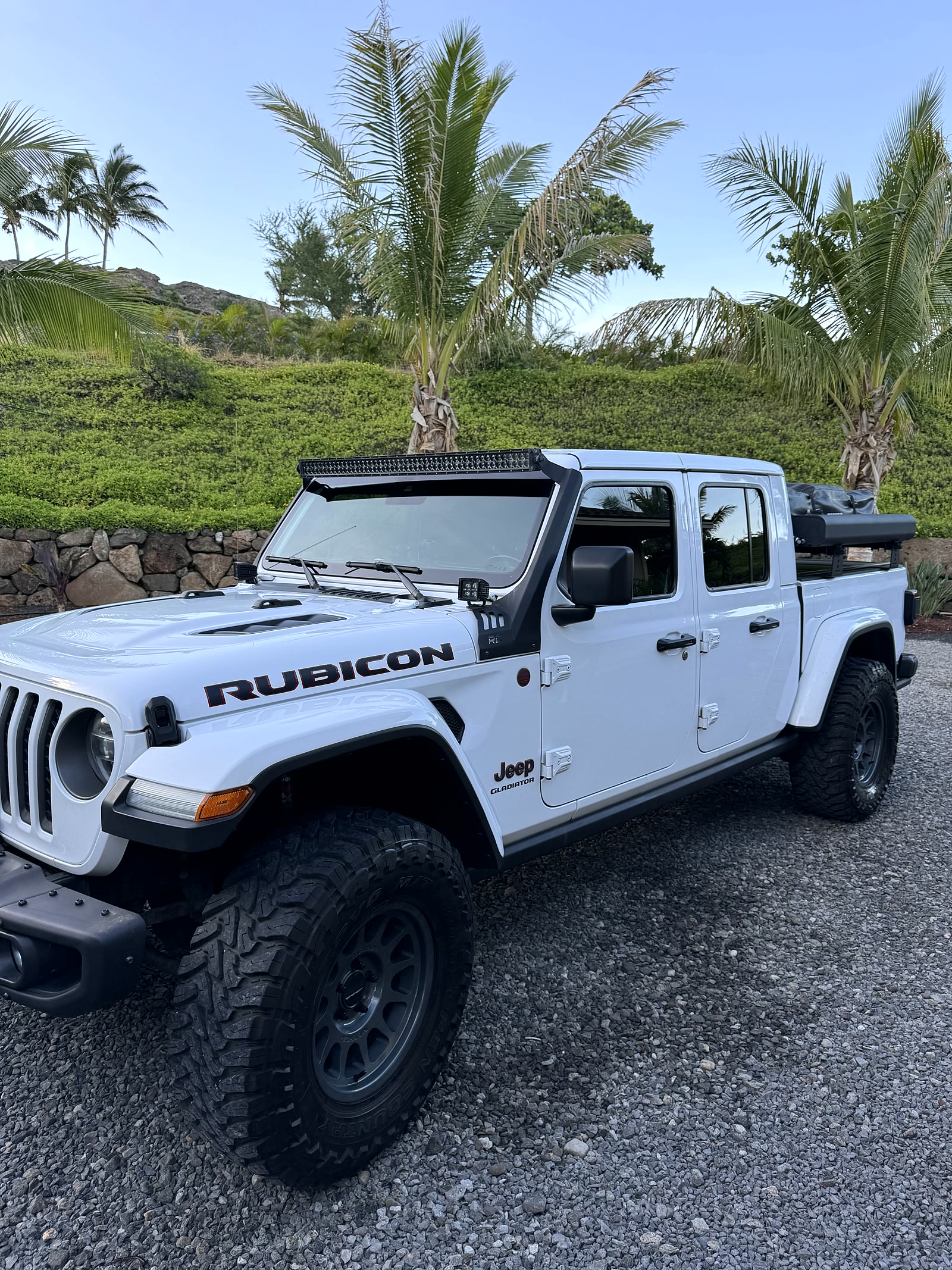 White 2020 Jeep Gladiator with Thule rooftop tent at the beach house