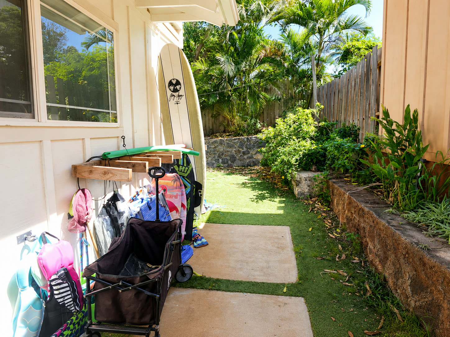 Side yard with outdoor shower and surfboard art